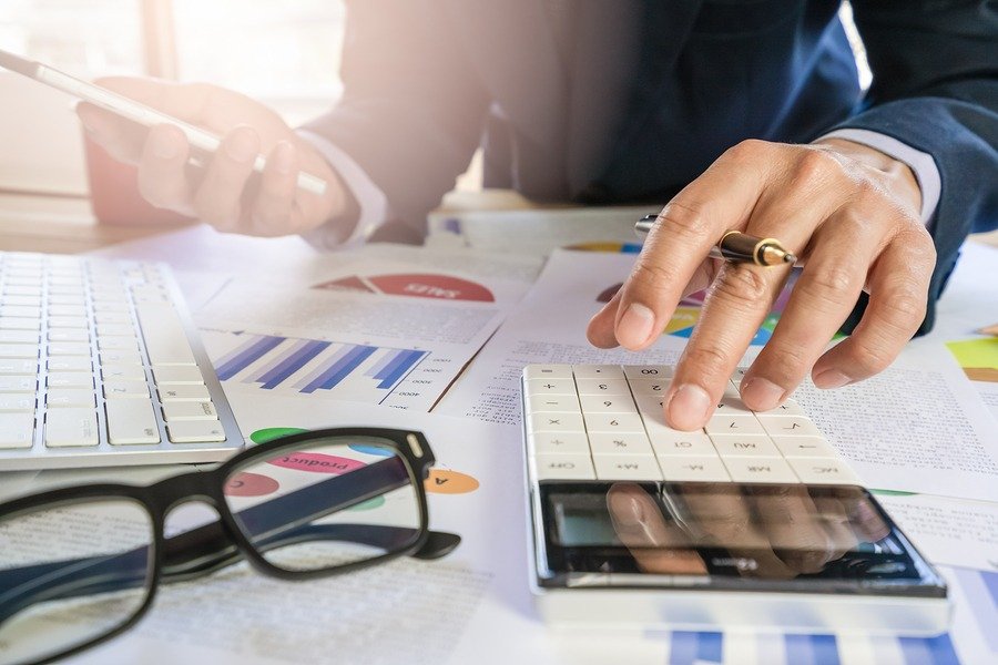 Businessman Or Accountant Working On Calculator To Calculate Bus
